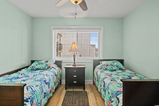 bedroom with ceiling fan and light hardwood / wood-style flooring