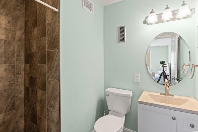 bathroom featuring toilet and vanity