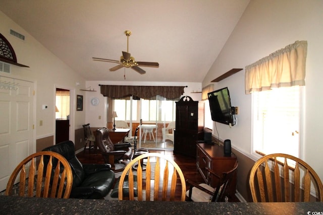 dining space with high vaulted ceiling, dark hardwood / wood-style floors, and ceiling fan