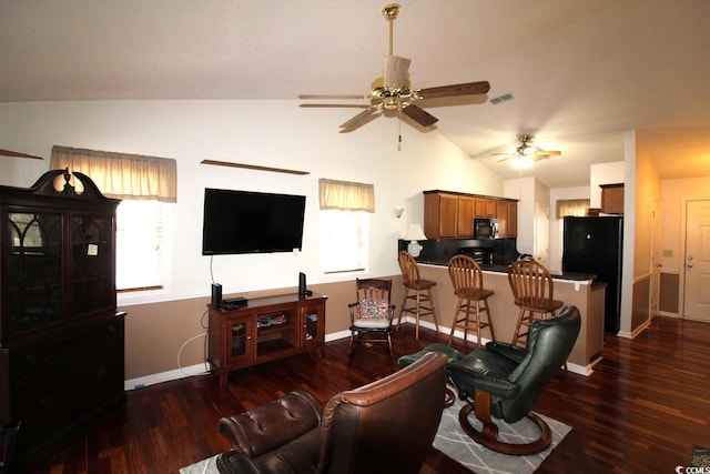 living room with vaulted ceiling, ceiling fan, and dark hardwood / wood-style flooring