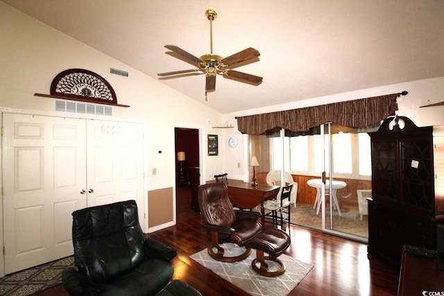 living room with vaulted ceiling, ceiling fan, and dark hardwood / wood-style flooring