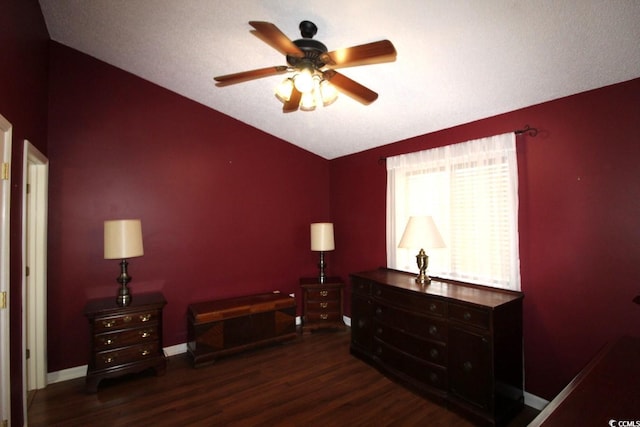 bedroom with lofted ceiling, dark hardwood / wood-style flooring, and ceiling fan