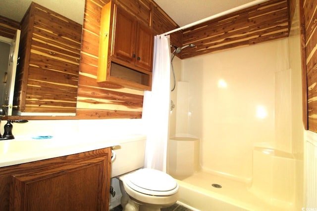 bathroom featuring toilet, sink, and a shower with curtain