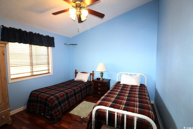 bedroom featuring lofted ceiling, dark wood-type flooring, and ceiling fan