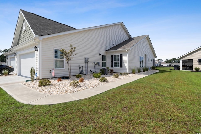 back of house featuring a garage and a yard