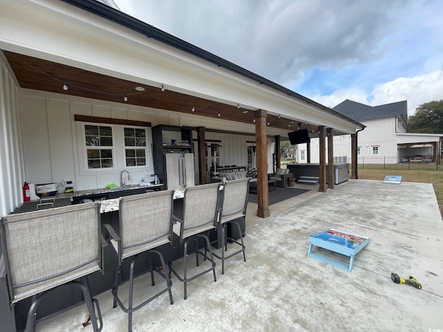 view of patio with an outdoor wet bar