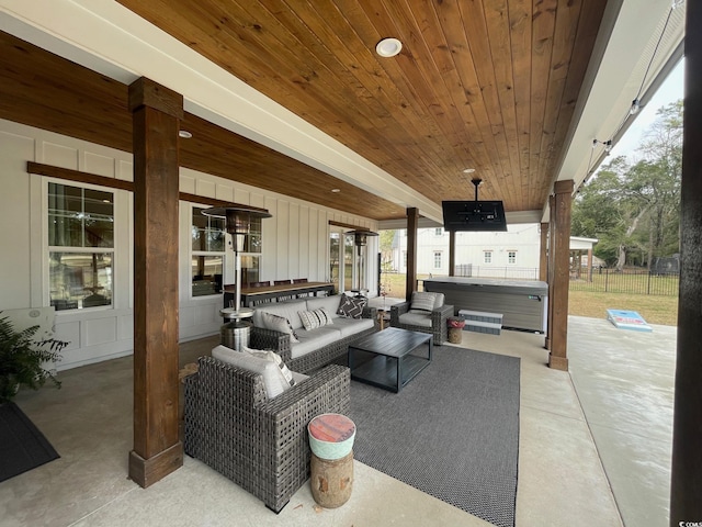 view of patio / terrace with an outdoor hangout area and a hot tub