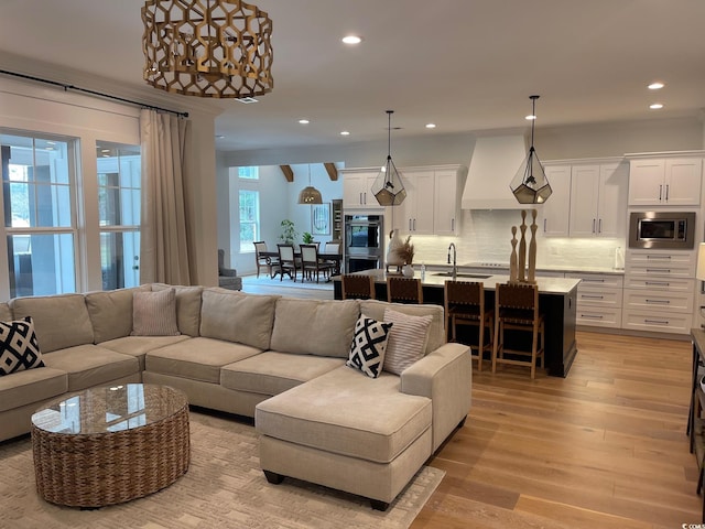 living room with light hardwood / wood-style flooring and sink