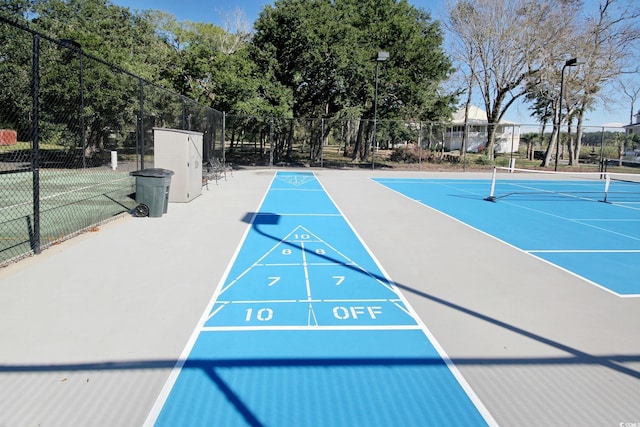 view of home's community with tennis court