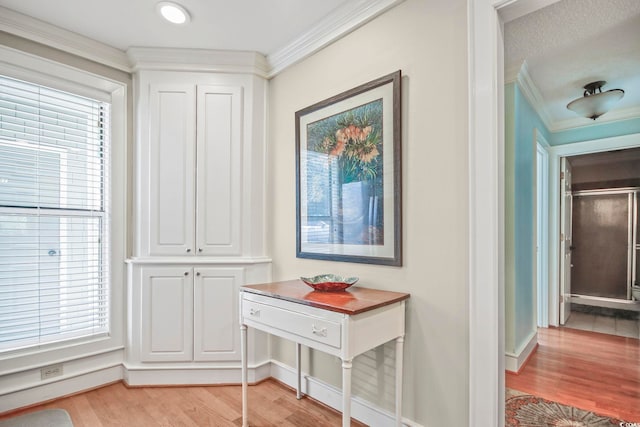 hall featuring crown molding and light wood-type flooring