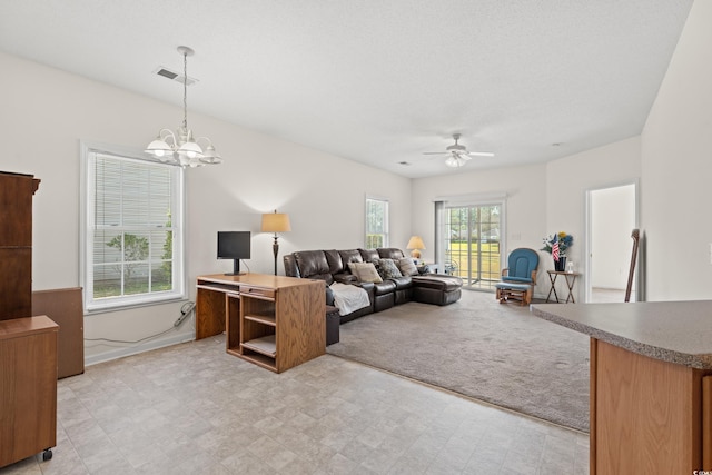 living room with light tile flooring and ceiling fan with notable chandelier