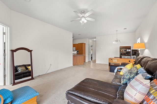 carpeted living room with ceiling fan with notable chandelier