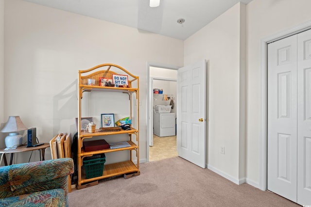 living area with light carpet and washer / clothes dryer