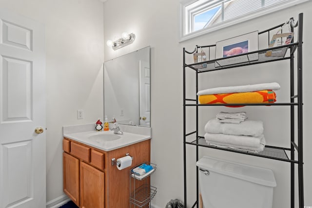 bathroom featuring toilet and vanity