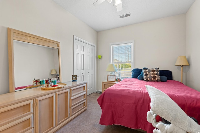 bedroom featuring a closet, light colored carpet, and ceiling fan