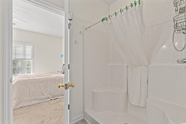 bathroom featuring a shower with curtain and a textured ceiling