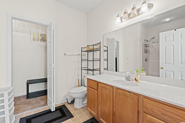 bathroom with tile flooring, toilet, and vanity