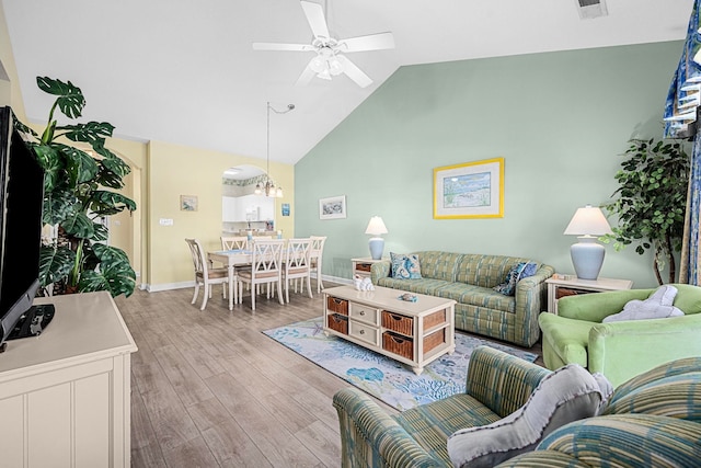 living room with high vaulted ceiling, ceiling fan, and hardwood / wood-style floors