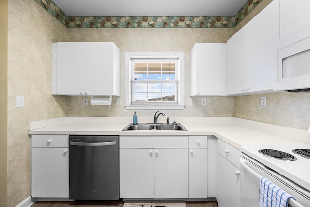 kitchen with sink, white appliances, white cabinetry, and dark wood-type flooring