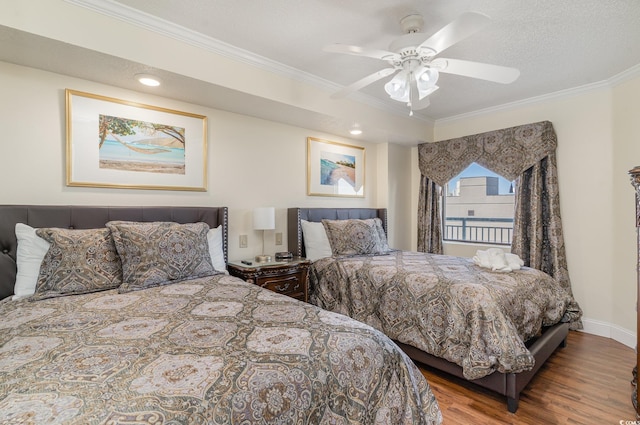 bedroom with ceiling fan, a textured ceiling, ornamental molding, and hardwood / wood-style floors