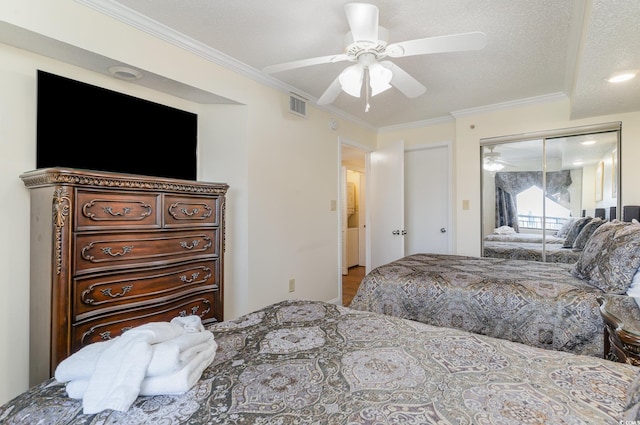 bedroom with a closet, ceiling fan, wood-type flooring, a textured ceiling, and crown molding