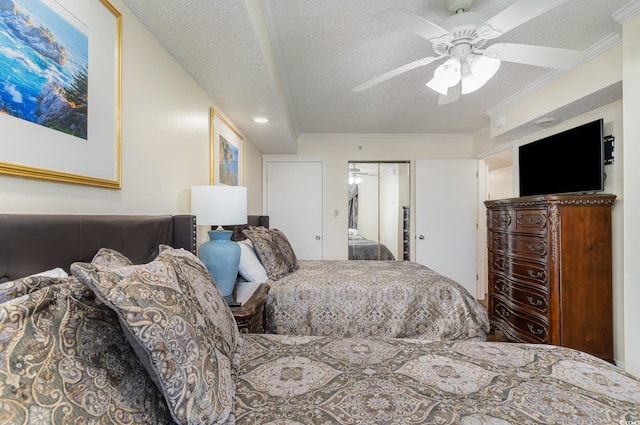 bedroom featuring ceiling fan, a closet, ornamental molding, and a textured ceiling