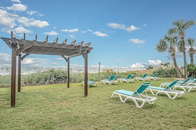 surrounding community featuring a pergola and a lawn