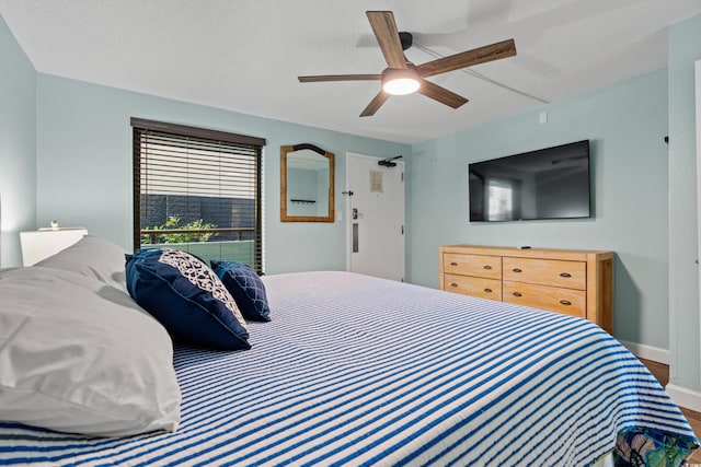 bedroom featuring ceiling fan, a textured ceiling, and hardwood / wood-style flooring