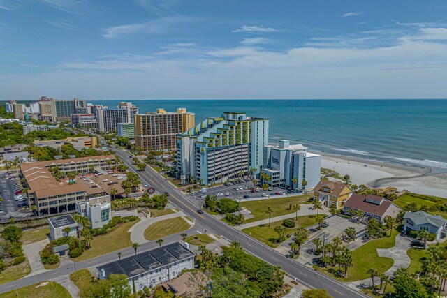 drone / aerial view featuring a beach view and a water view