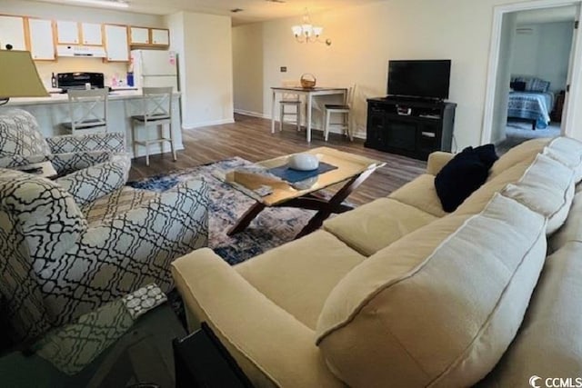 living room with hardwood / wood-style floors and a notable chandelier