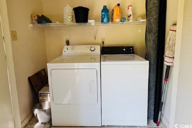 clothes washing area with separate washer and dryer