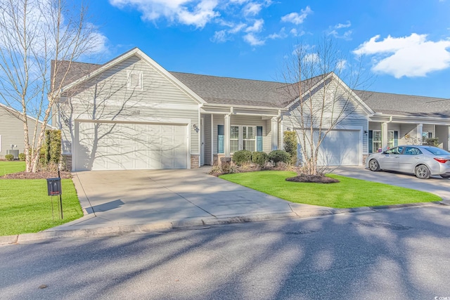 ranch-style home featuring a garage and a front yard