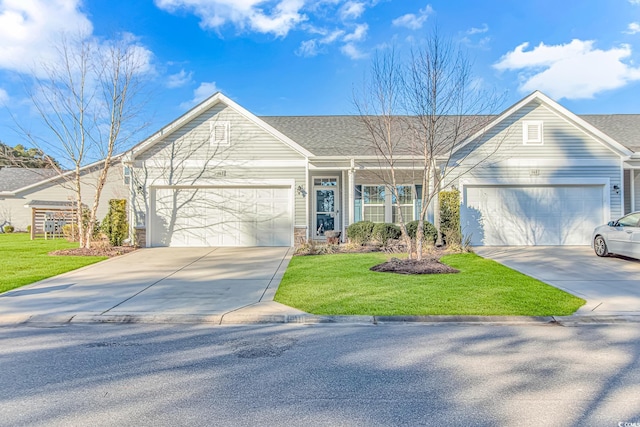 view of front of house with a front yard and a garage