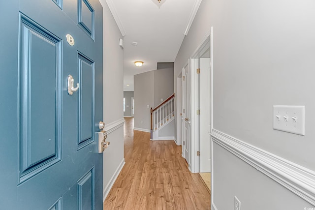 entrance foyer with light hardwood / wood-style floors and ornamental molding