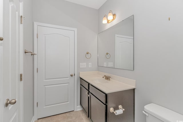 bathroom with tile patterned floors, vanity, and toilet