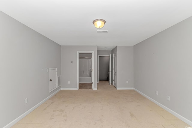 unfurnished bedroom featuring light carpet