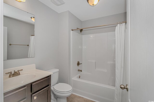 full bathroom featuring tile patterned floors, vanity, shower / bath combination with curtain, and toilet