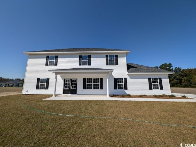 view of front facade featuring a patio area and a front yard