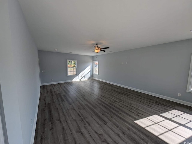 unfurnished living room with dark wood finished floors, recessed lighting, a ceiling fan, and baseboards