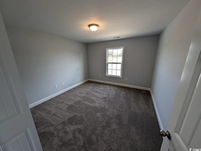 carpeted empty room with visible vents and baseboards