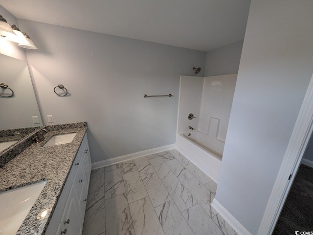 bathroom featuring double vanity, baseboards, marble finish floor, and a sink