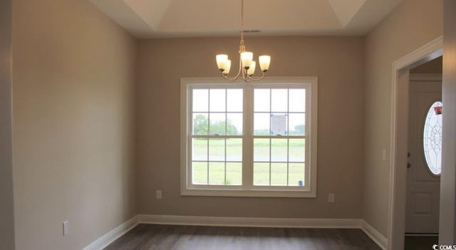 interior space featuring an inviting chandelier and dark wood-type flooring