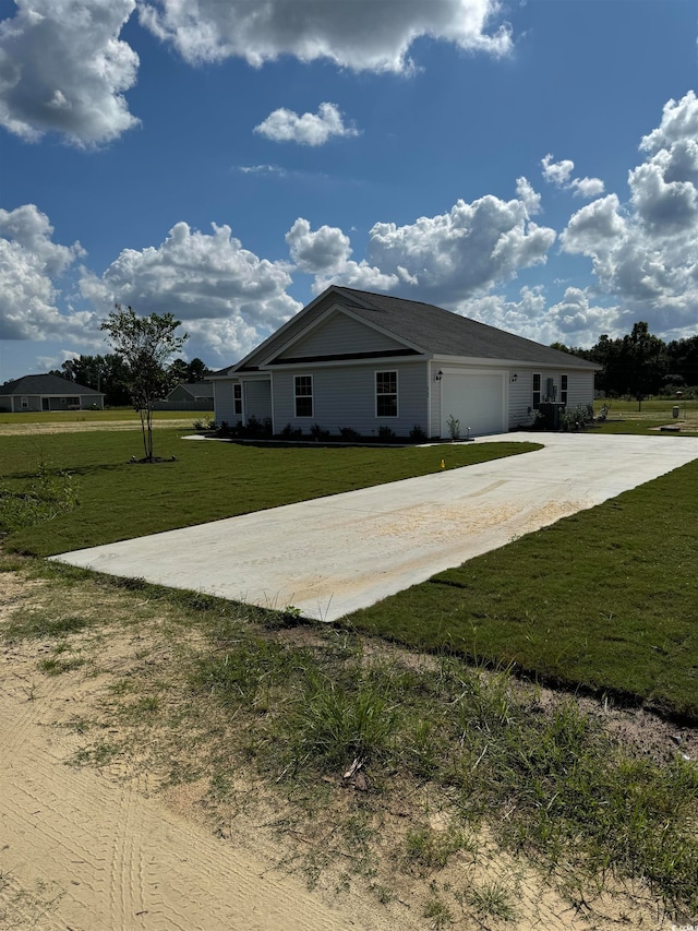 view of home's exterior featuring a lawn and a garage