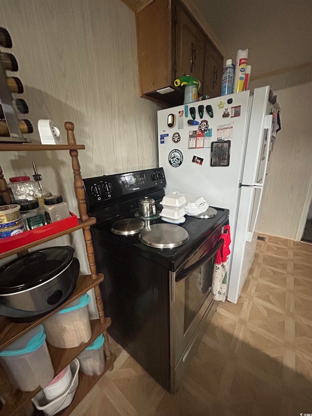 kitchen with electric stove and light parquet flooring