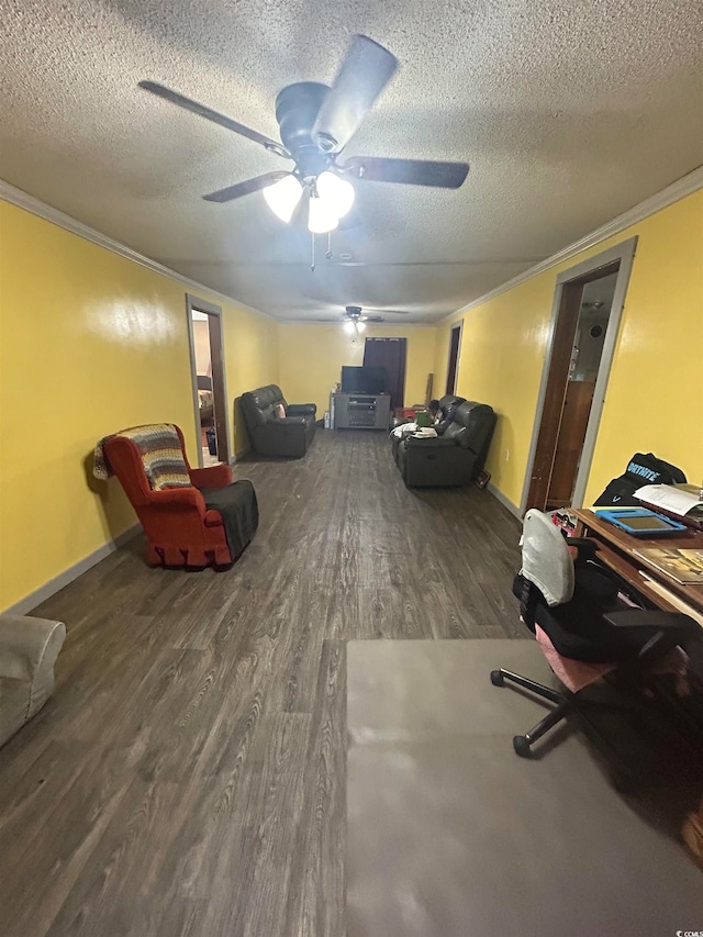 interior space featuring ceiling fan, ornamental molding, a textured ceiling, and hardwood / wood-style flooring