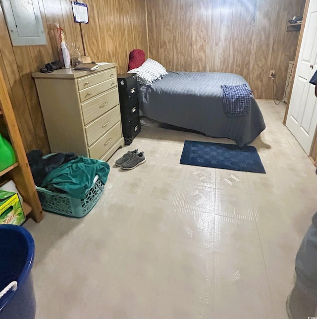 bedroom featuring wood walls