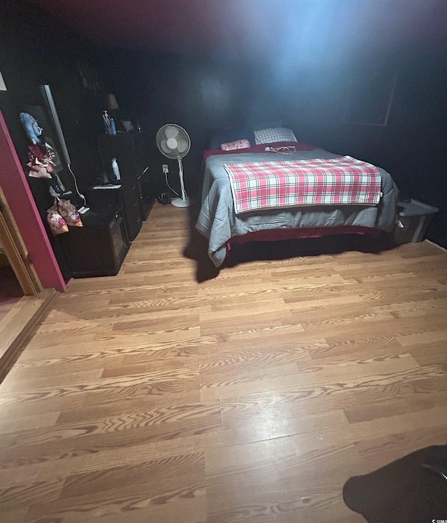 bedroom with hardwood / wood-style floors