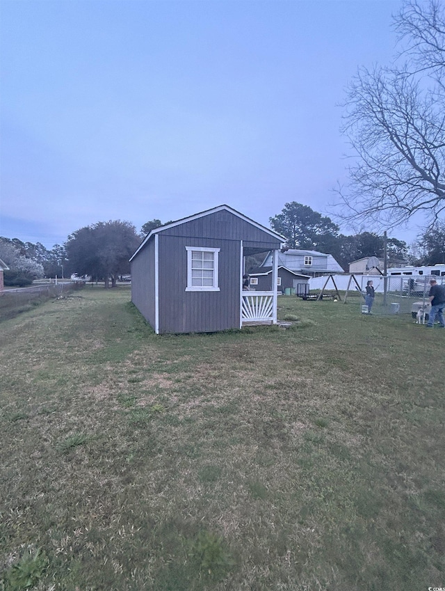 view of outdoor structure featuring a lawn