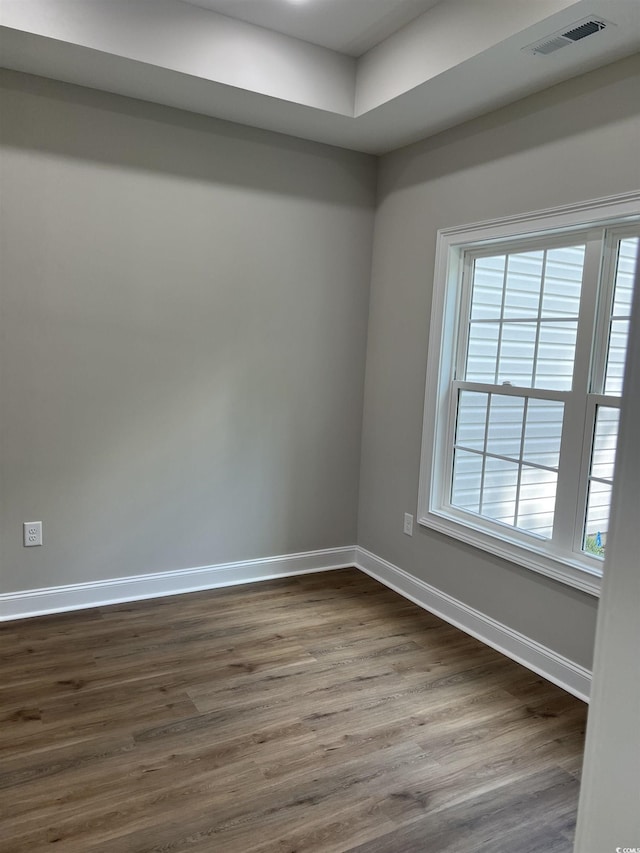 spare room with visible vents, plenty of natural light, and baseboards