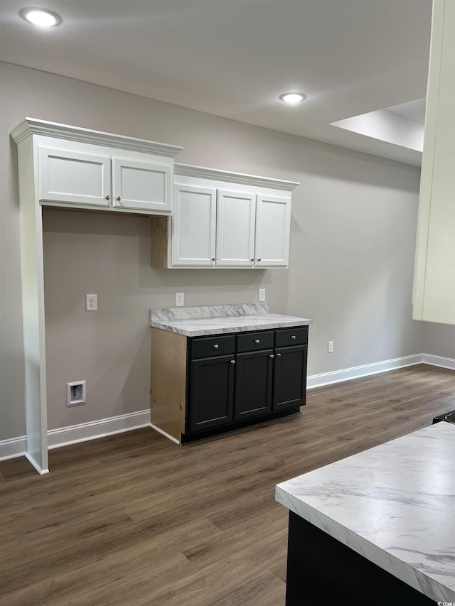 kitchen featuring white cabinetry, baseboards, and dark wood-style flooring